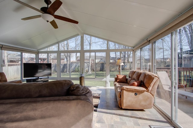 sunroom / solarium featuring a healthy amount of sunlight, vaulted ceiling with beams, and ceiling fan