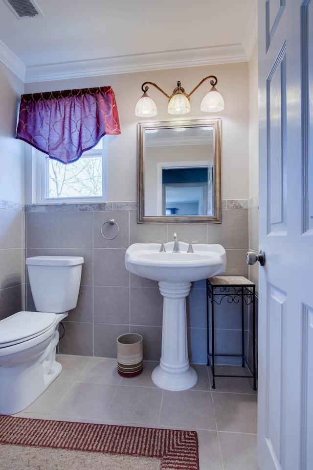 bathroom featuring tile patterned flooring, crown molding, toilet, and visible vents