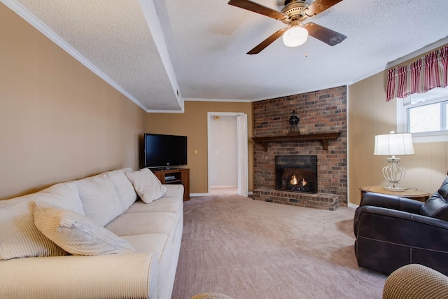 carpeted living room with a ceiling fan, a textured ceiling, a brick fireplace, and crown molding