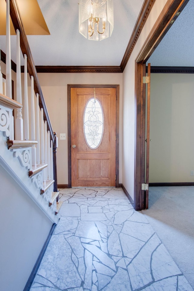 foyer with stairway, baseboards, ornamental molding, a textured ceiling, and light carpet