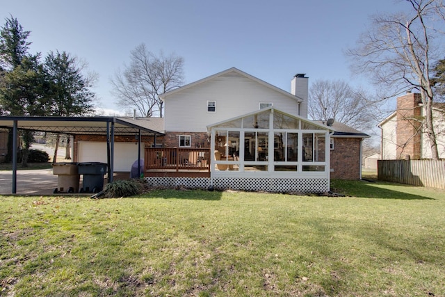 back of house featuring a lawn, fence, a sunroom, brick siding, and a chimney