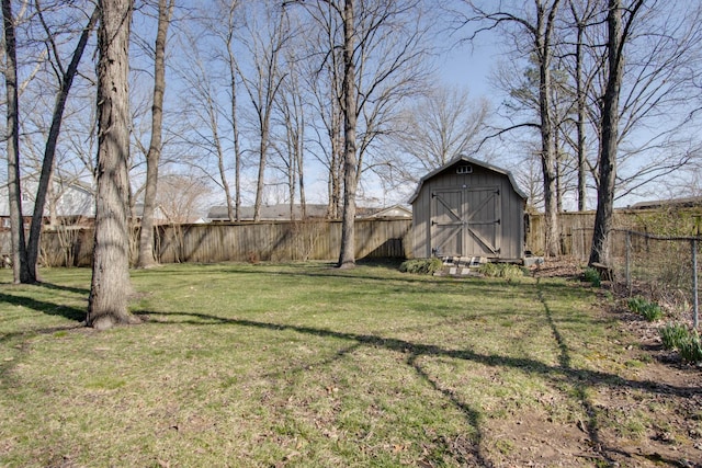 view of yard featuring an outbuilding, a storage unit, and a fenced backyard