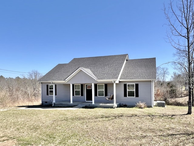 view of front of home with covered porch, central AC, a shingled roof, a front lawn, and crawl space