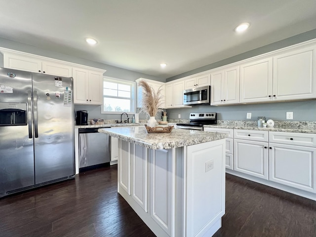 kitchen with white cabinetry, dark wood-style flooring, and appliances with stainless steel finishes