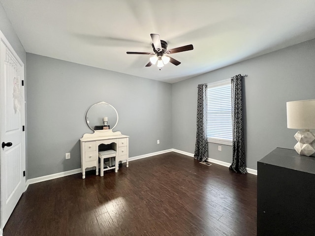 office featuring a ceiling fan, wood finished floors, and baseboards