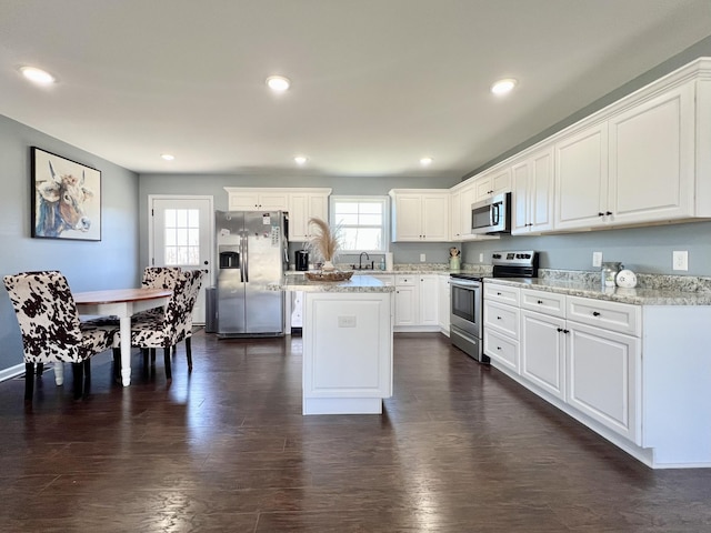 kitchen featuring a wealth of natural light, appliances with stainless steel finishes, dark wood-type flooring, and a sink