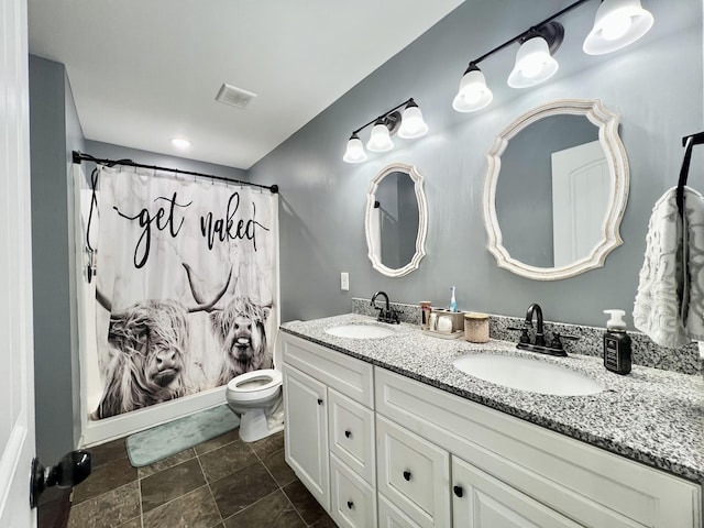 bathroom with double vanity, toilet, visible vents, and a sink