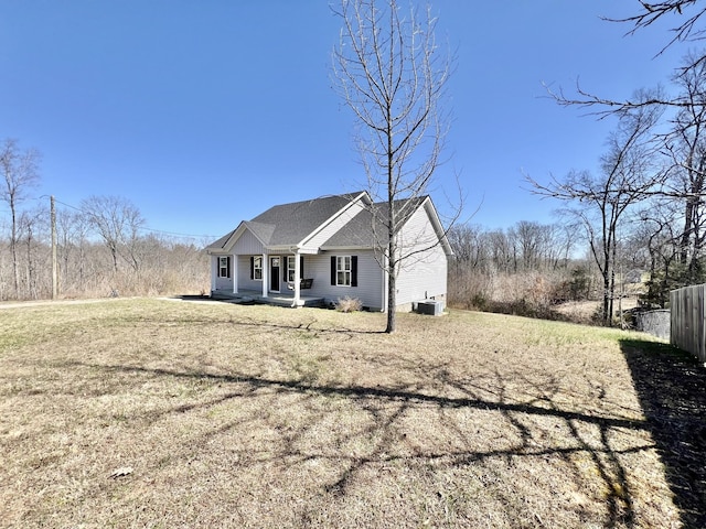 view of front of home with a front yard and fence