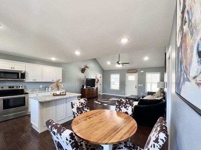 dining room with baseboards, lofted ceiling, recessed lighting, dark wood-style floors, and a ceiling fan