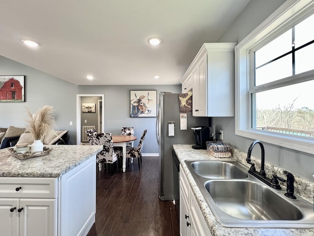 kitchen featuring dark wood finished floors, light countertops, recessed lighting, white cabinets, and a sink