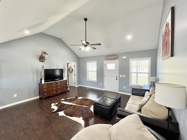 living room with baseboards, dark wood-type flooring, a healthy amount of sunlight, and vaulted ceiling