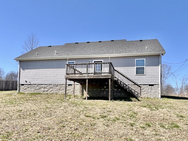 back of house featuring roof with shingles, stairs, crawl space, a deck, and a lawn