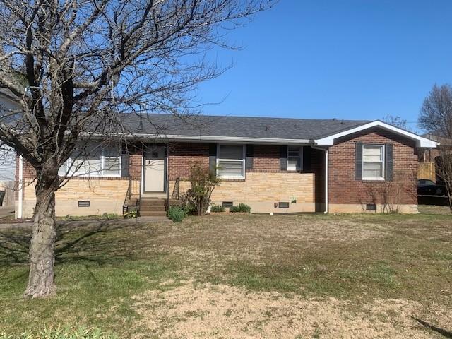 ranch-style home featuring a front lawn, brick siding, and crawl space