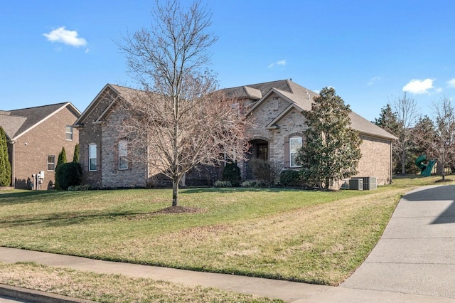 view of front of house with brick siding and a front lawn