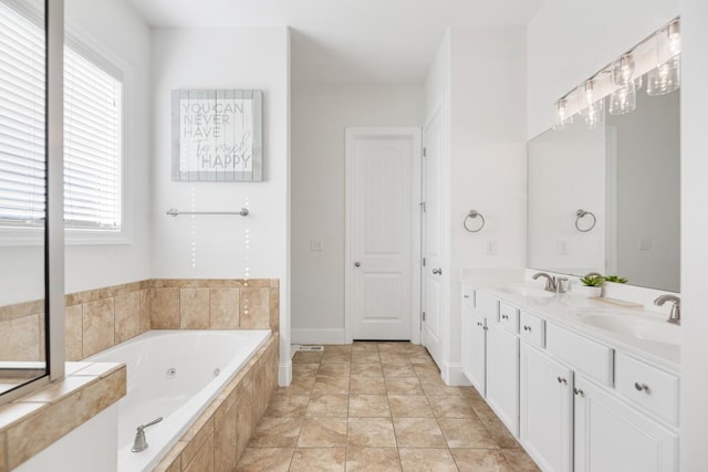 bathroom featuring double vanity, a whirlpool tub, tile patterned floors, and a sink