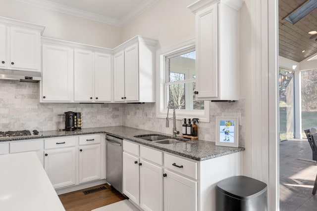 kitchen featuring a sink, stainless steel appliances, under cabinet range hood, and white cabinets