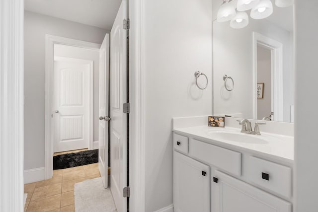 bathroom with tile patterned floors, baseboards, and vanity