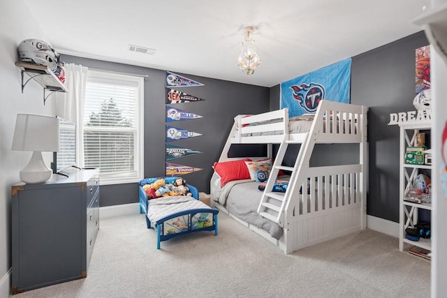 bedroom with visible vents, a notable chandelier, carpet, and baseboards