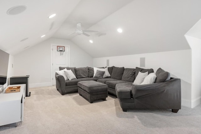 living area featuring a ceiling fan, vaulted ceiling, light colored carpet, and baseboards