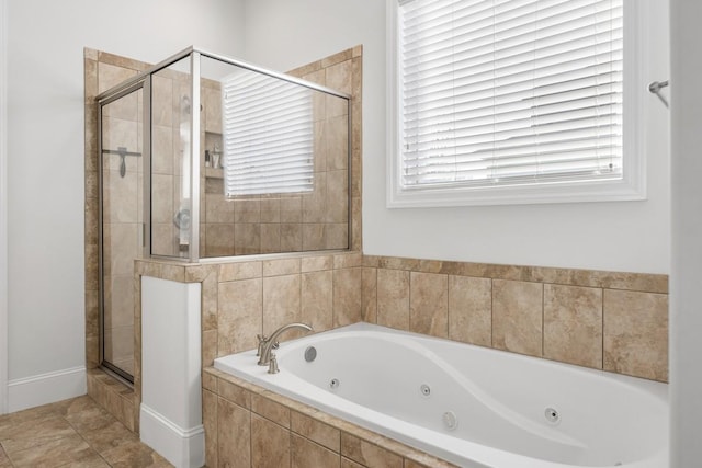 bathroom with a jetted tub and a shower stall