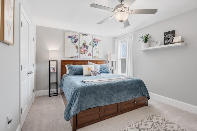 carpeted bedroom featuring a ceiling fan and baseboards