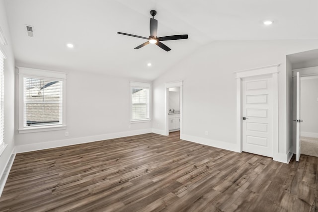 unfurnished bedroom with vaulted ceiling, wood finished floors, visible vents, and baseboards