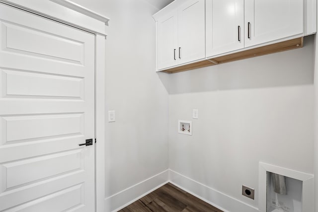 laundry room featuring electric dryer hookup, cabinet space, baseboards, hookup for a washing machine, and dark wood-style flooring