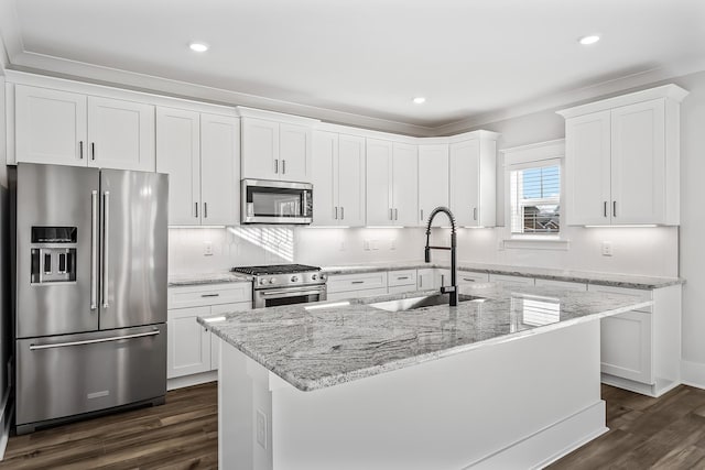 kitchen with white cabinets, dark wood-style floors, appliances with stainless steel finishes, and a sink