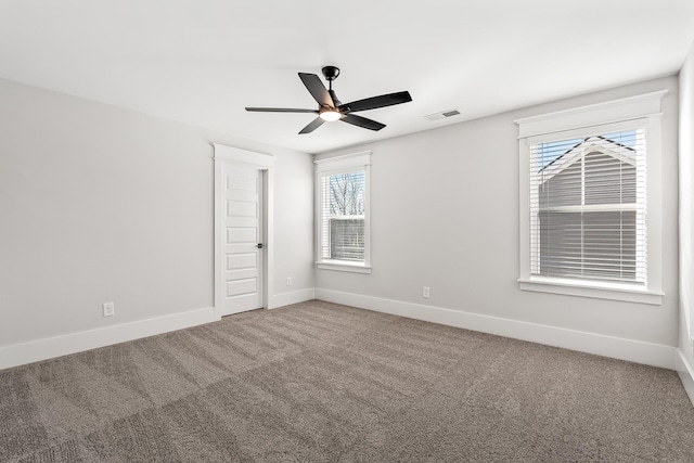 spare room with visible vents, baseboards, carpet, and ceiling fan