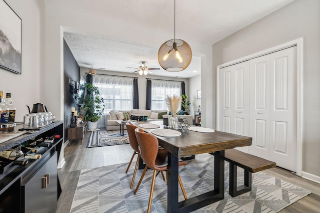 dining area with wood finished floors and a textured ceiling