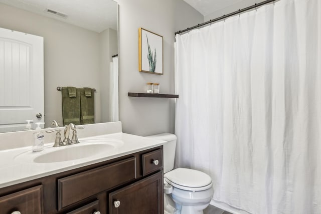 full bathroom with visible vents, toilet, and vanity