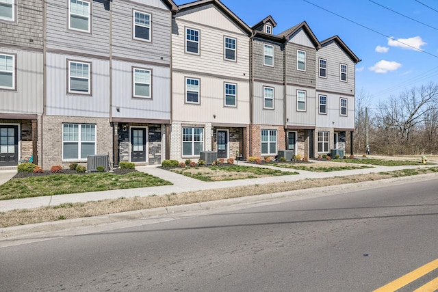 multi unit property featuring central AC unit and brick siding