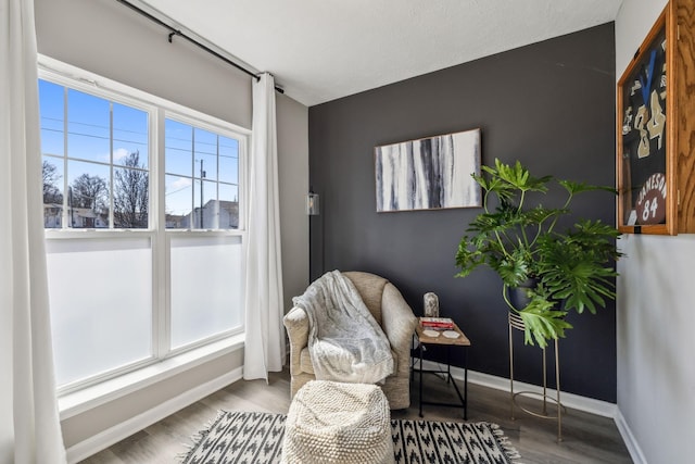 sitting room featuring wood finished floors and baseboards