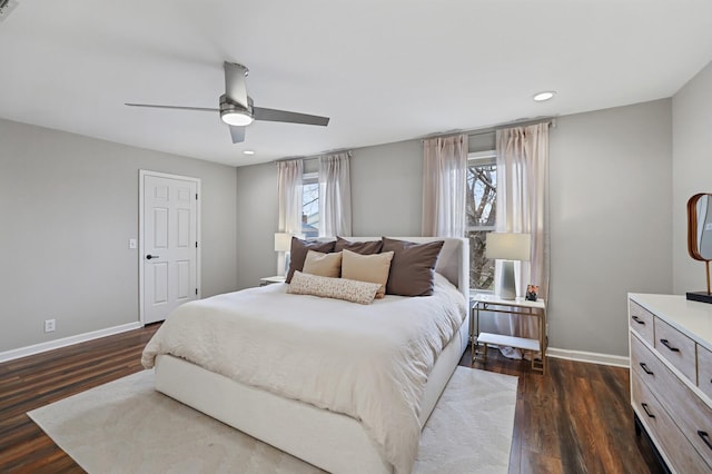 bedroom with baseboards, ceiling fan, and dark wood-style flooring