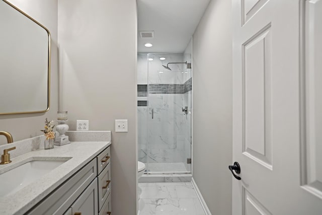 full bath featuring vanity, baseboards, a marble finish shower, toilet, and marble finish floor