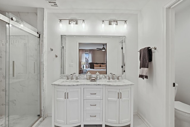 ensuite bathroom with a marble finish shower, visible vents, toilet, ensuite bathroom, and a sink