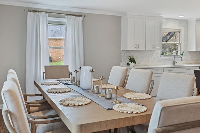 dining space with crown molding