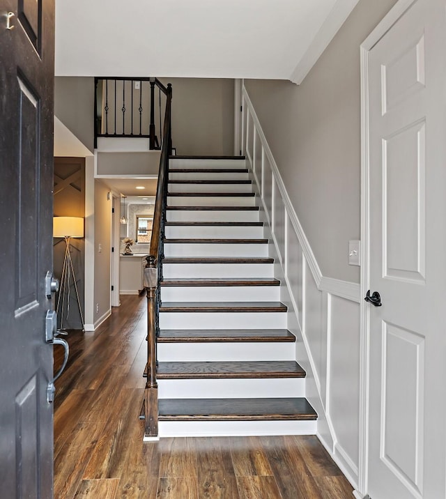 stairs with wood finished floors and baseboards