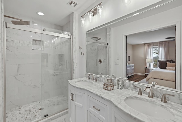 full bath with a sink, visible vents, a marble finish shower, and ensuite bath