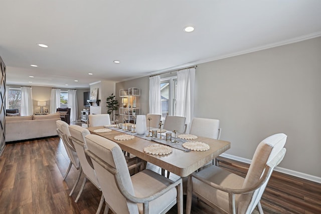 dining space with dark wood-type flooring, recessed lighting, baseboards, and ornamental molding