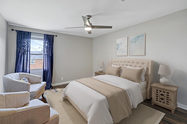 bedroom featuring wood finished floors, baseboards, and ceiling fan