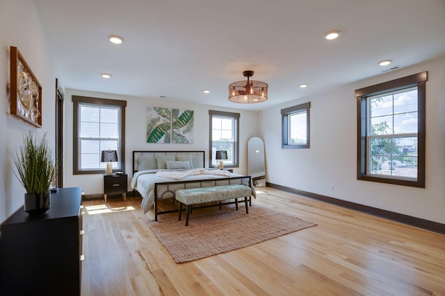 bedroom with recessed lighting, baseboards, and light wood-style floors