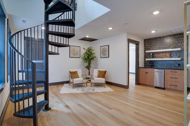 interior space with visible vents, recessed lighting, stairway, light wood finished floors, and baseboards