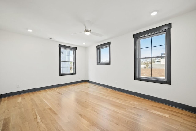 unfurnished room featuring recessed lighting, light wood-style floors, and baseboards