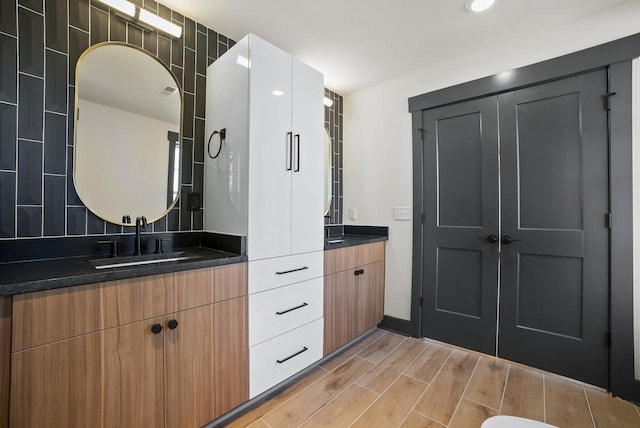 full bath featuring vanity and wood finish floors