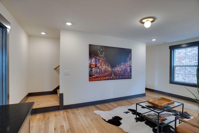 living area featuring recessed lighting, baseboards, and light wood-type flooring