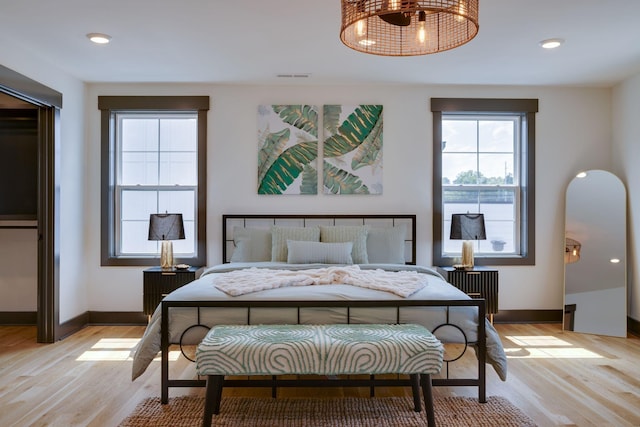 bedroom featuring visible vents, baseboards, and light wood-style flooring