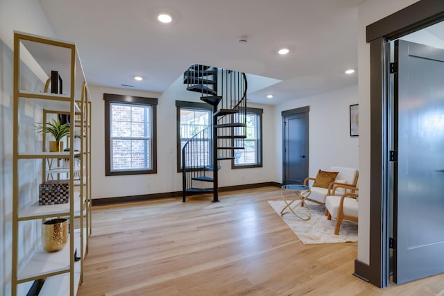 entrance foyer featuring light wood finished floors, stairway, recessed lighting, and baseboards