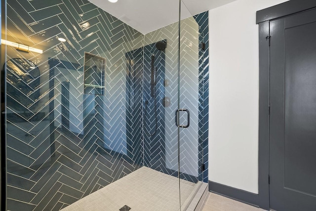 bathroom featuring tile patterned flooring and a stall shower