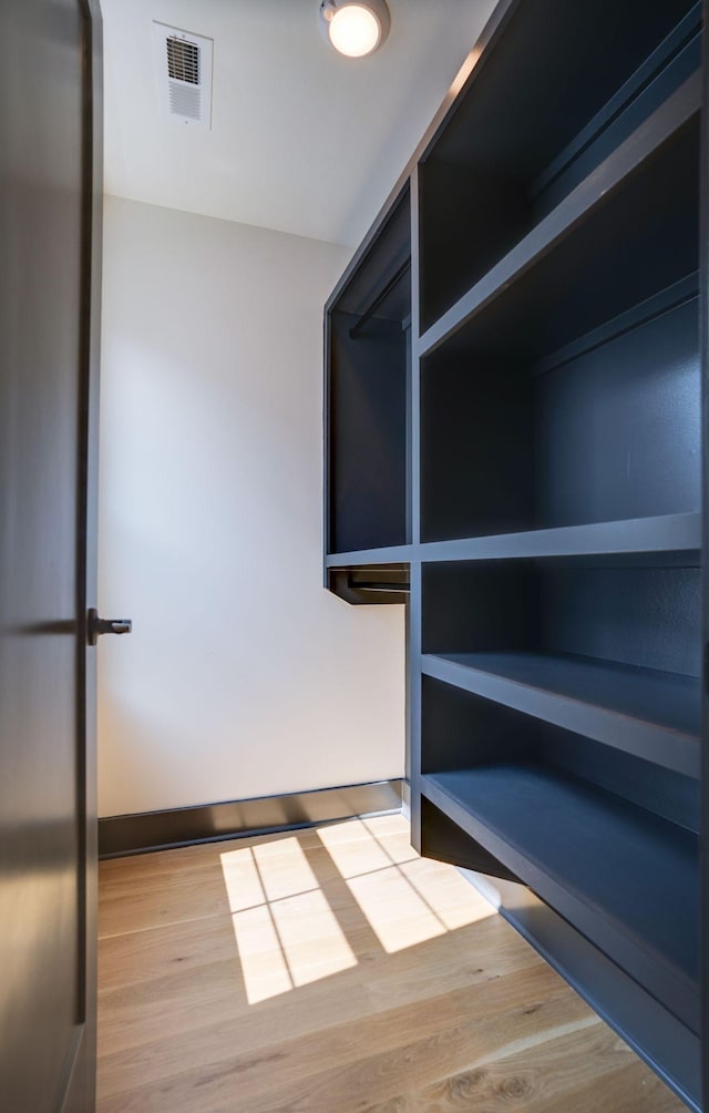 interior space with visible vents and wood finished floors